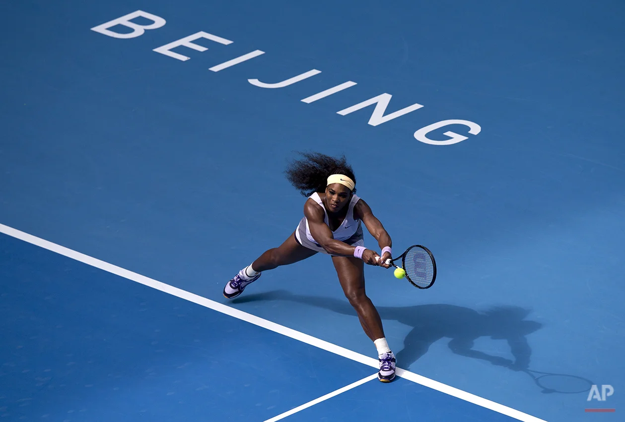 Serena Williams of the U.S. returns a shot to Francesca Schiavone of Italy during the second round of the China Open tennis tournament at the National Tennis Stadium in Beijing, China Tuesday, Oct. 1, 2013. (AP Photo/Andy Wong)