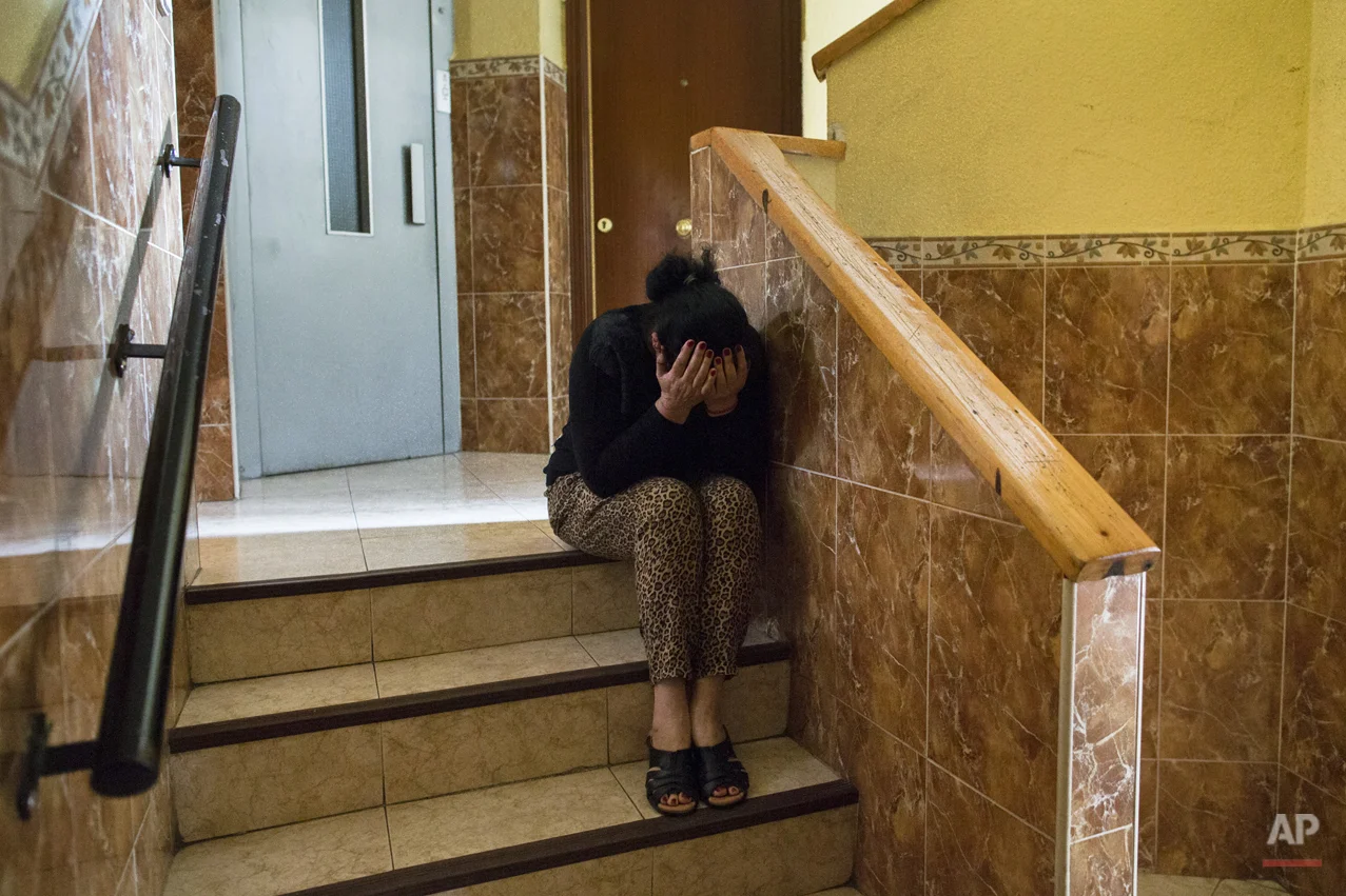 Carmen Escudero Garcia, 59 years old, cries as she waits for the police to evict her son, Jose Garcia Escudero, 39, and his family in Madrid, Spain, Monday, May 19, 2014. Escudero and his 30 year old wife Raquel de Cadiz Escudero, have 5 children and they occupied a Banco Popular bank apartment over a year ago and they cannot afford to pay the rent with a low income of 600 euros ($823) a month. The apartment has been sold to an investor group that now demands the eviction of the family. The eviction was postponed for 9 days with the help of housing rights activists. (AP Photo/Andres Kudacki)