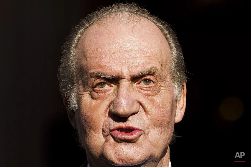 In this Tuesday, Dec. 27, 2011, file photo Spain's King Juan Carlos leaves after the official opening of the Parliament, in Madrid. Spain's King Juan Carlos plans to abdicate and pave the way for his son, Crown Prince Felipe, to take over, Spanish Prime Minister Mariano Rajoy told the country Monday in an announcement broadcast nationwide. The 76-year-old Juan Carlos oversaw his country's transition from dictatorship to democracy but has had repeated health problems in recent years. (AP Photo/Daniel Ochoa de Olza)