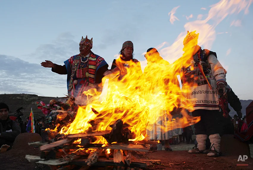 Andean religious leaders perform a new year ritual at the ruins of the ancient civilization of Tiwanaku located in the highlands in Tiwanaku, Bolivia, early Saturday, June 21, 2014. Bolivia's Aymara Indians are celebrating the year 5,522 as well as the Southern Hemisphere's winter solstice, which marks the start of a new agricultural cycle. (AP Photo/Juan Karita)