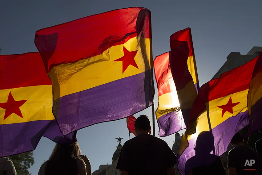 Protestors march as they wave Republican flags during a demonstration against the Spanish Monarchy and demanding a referendum in Madrid, Spain, Saturday, June 7, 2014. King Juan Carlos plans to abdicate and pave the way for his son, Crown Prince Felipe, to become the country's next king. The 76-year-old Juan Carlos oversaw his country's transition from dictatorship to democracy but has had repeated health problems in recent years, and his popularity dipped following royal scandals. (AP Photo/Andres Kudacki)