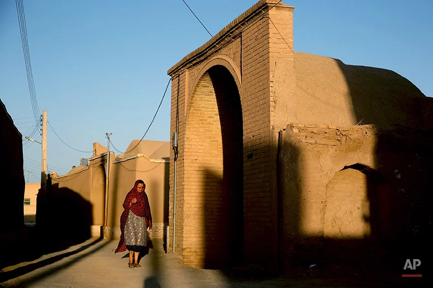 In this Friday, June 13, 2014 photo, a Zoroastrian woman makes her way after performing prayers at a temple in Ardakan, 330 miles (550 kilometers) southeast of the capital Tehran, Iran. Zoroastrianism is a monotheistic religion predating Christianity, Islam and Judaism, founded some 3,800 years ago by the prophet Zoroaster. It was the dominant religion in Persia before the Arab conquest. (AP Photo/Ebrahim Noroozi)