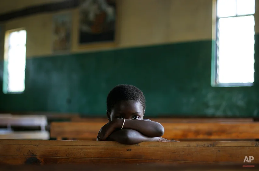A Congolese child sits in the Kiwanja catholic church, North of Rutshuru, 75 km (48 miles) North of Goma, Congo, Sunday Aug. 5, 2012. 2012. Congo's army now controls only the city of Goma and the village of Kibumba, 10 kilometers (six miles) outside Goma. Now the rebels hold all towns going north as far as Rutshuru and are threatening to besiege Goma. The U.N. Security Council on Thursday demanded that the M23 rebel group halt any advances toward Goma. (AP Photo/Jerome Delay)