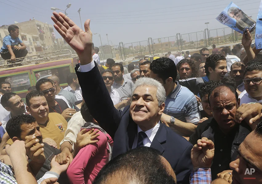 Presidential hopeful Hamdeen Sabahi waves to his supporters in Baltim city, 212 kilometers (132 miles) North of Cairo, Egypt, Friday, May 16, 2014. With only two people - former army chief Abdel-Fattah el-Sissi and leftist politician Hamdeen Sabahi - vying for the country's top post, the Egyptian election commission set the first round of voting for May 26 and 27, with results expected by June 5. (AP Photo/Amr Nabil)