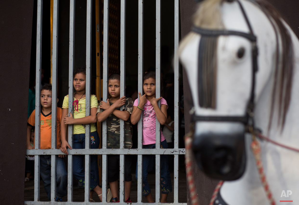  In this Aug. 4, 2015 photo, a group of children stands inside the Santo Domingo church during Managua's patron saint, Santo Domingo de Guzman's celebration, in Managua, Nicaragua. Nicaraguans of all classes and from all walks of life, from small chi