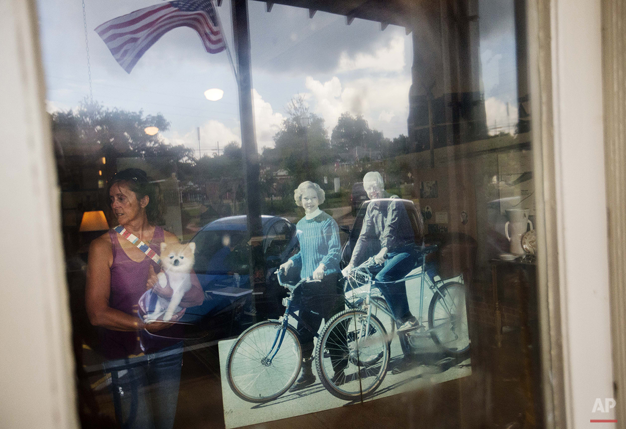  A visitor walks near a cutout of former President Jimmy Carter and his wife, Rosalynn, at an antique mall in Carter's hometown of Plains, Ga., Sunday, Aug. 23, 2015. Residents of Plains say they’re grateful that Carter has never forgotten his hometo