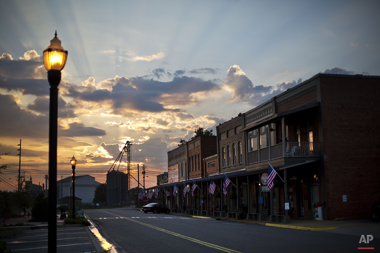  The sun rises behind Main Street in the hometown of former President Jimmy Carter in Plains, Ga., Sunday, Aug. 23, 2015. Carter and his hometown have always been intertwined, from the day he announced he would run for president and an old train depo