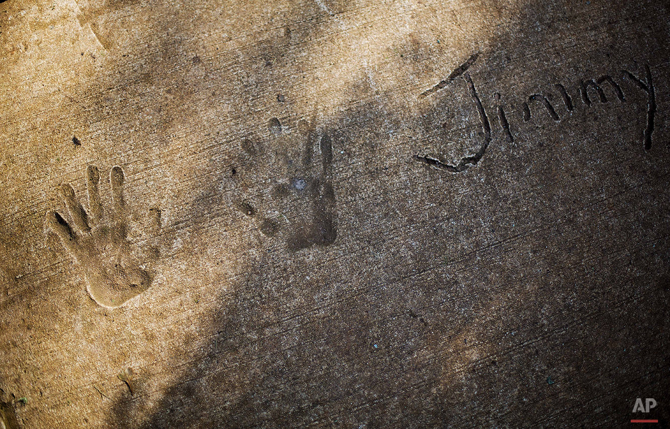  The handprints of former President Jimmy Carter are cast in the sidewalk outside his boyhood farm in Plains, Ga., Saturday, Aug. 22, 2015. Residents of Plains say they’re grateful that Carter has never forgotten his hometown. (AP Photo/David Goldman