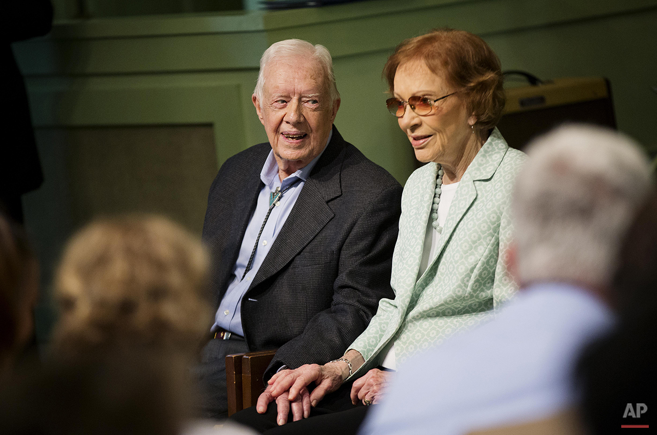  Former President Jimmy Carter, left, sits with his wife Rosalynn as they pose for photos after Carter taught Sunday School class at Maranatha Baptist Church in his hometown Sunday, Aug. 23, 2015, in Plains, Ga. The 90-year-old Carter gave one lesson