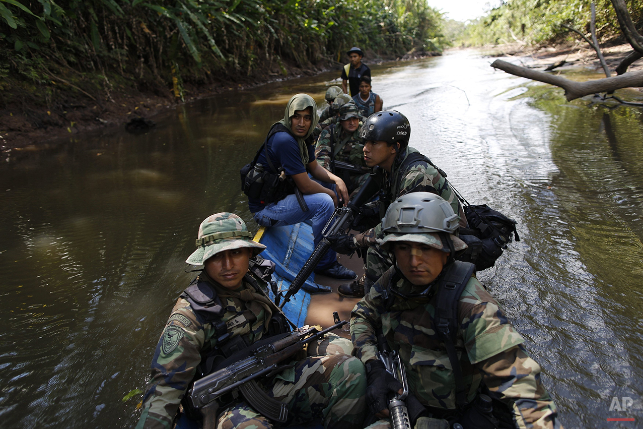  In this July 28, 2015 photo, counternarcotics special forces cross the Palcazu River as they head to crater a clandestine airstrip used by drug dealers in the Peruvian jungle near Ciudad Constitucion, Peru. The officers armed with assault rifles slo