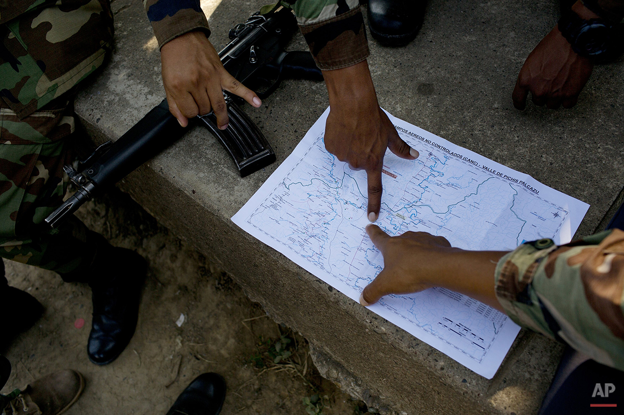  In this July 31, 2015 photo, counternarcotics special forces study a map at their headquarters, before starting an operation to destroy a clandestine airstrip, in Ciudad Constitucion, Peru. According to Rep. Emiliano Apaza, president of Congress’ de