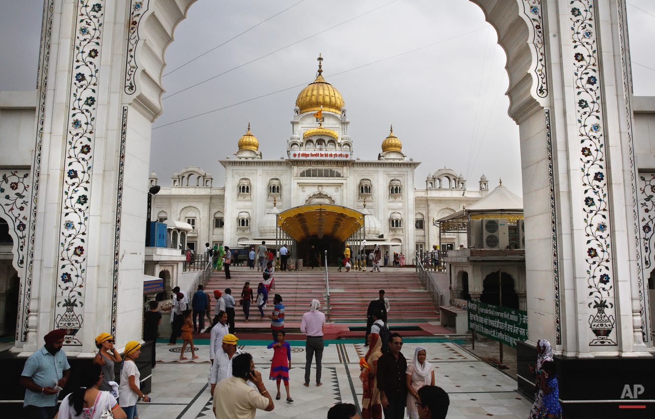  In this May 19, 2015 photo, devotees arrive at the Bangla Sahib Gurdwara or Sikh temple in New Delhi, India. Men, women and children throng the kitchen at Bangla Sahib, one of the biggest gurudwaras in India, that serves langar, which translates to 