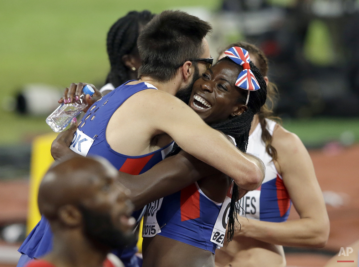  Martyn Rooney and Britain's Christine Ohuruogu of the British men's and women's 4x400m relay teams embrace after both won bronze medals at the World Athletics Championships at the Bird's Nest stadium in Beijing, Sunday, Aug. 30, 2015. (AP Photo/Darr