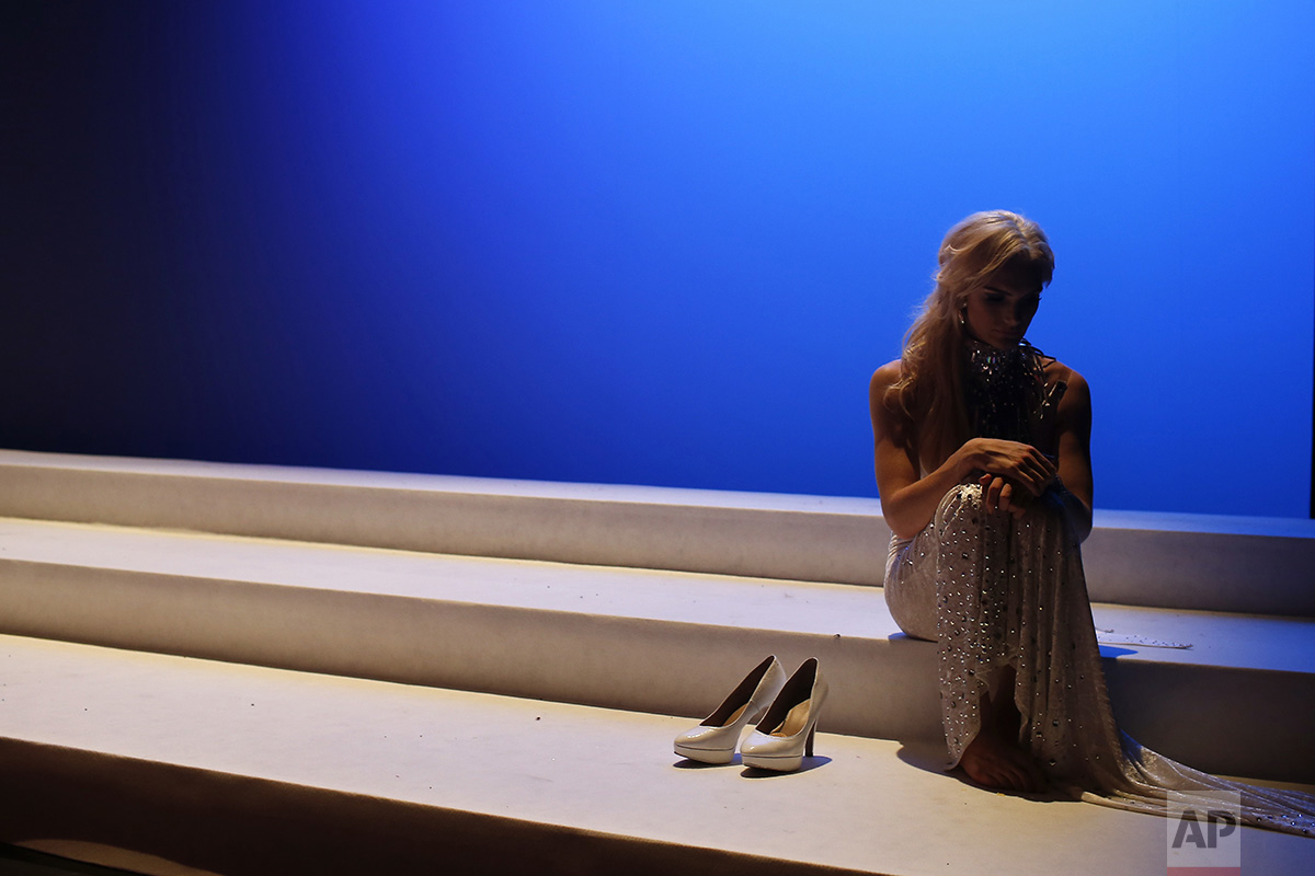  In this Sunday, Sept. 18, 2016 photo, Linni Rows Wiman, from Sweden, sits on the stage during an interval in the Miss Trans Star International 2016 show celebrated in Barcelona, Spain. Twenty-eight women representing as many countries competed last 