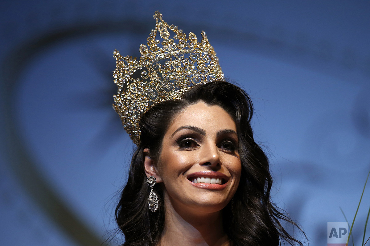 In this Sunday, Sept. 18, 2016 photo, the representative of Brazil, Rafaela Manfrini, smiles wearing the crown of the new Miss International Trans Star 2016, during a show celebrated in Barcelona, Spain. To be eligible to compete, contestants are no