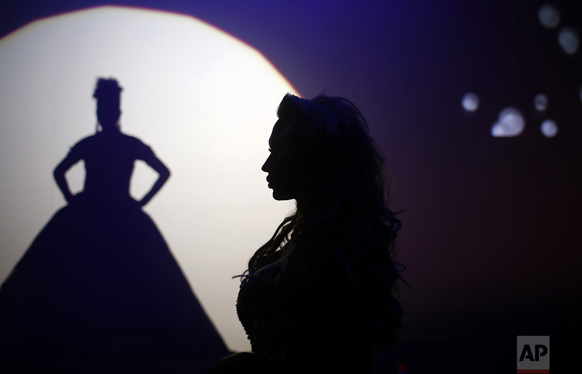  In this Sunday, Sept. 18, 2016 photo, Britanie Eichenholc, from France, right, is seen silhouetted during her performance at the Miss Trans Star International 2016 show celebrated in Barcelona, Spain. (AP Photo/Manu Fernandez) 