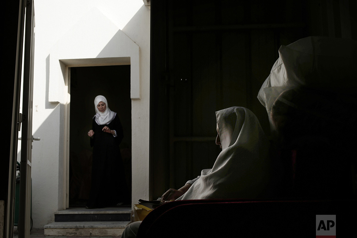  In this Sunday, Sept. 11, 2016 photo, an Egyptian woman prays inside the women's camp in Arafat during the annual hajj pilgrimage, near the holy city of Mecca, Saudi Arabia. The pilgrimage, required of able-bodied Muslims once in their life, brings 