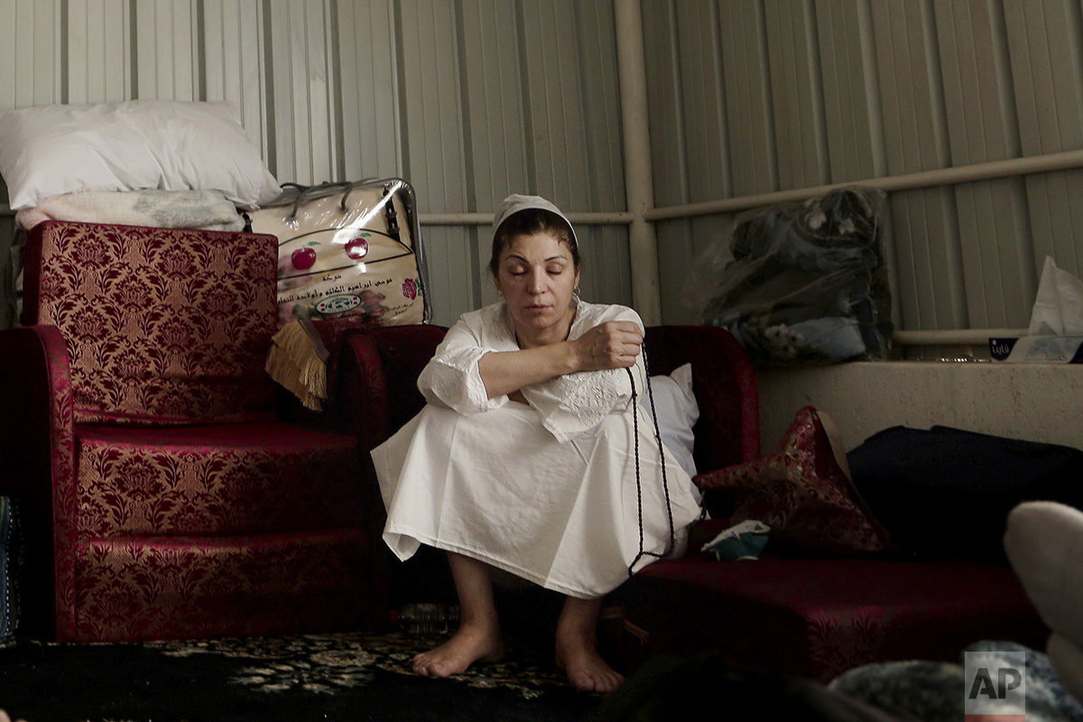  In this Sunday, Sept. 11, 2016 photo, an Iraqi woman uses her prayer beads to make tasbeeh, or meditation, inside the women's camp in Arafat during the annual hajj pilgrimage, near the holy city of Mecca, Saudi Arabia. (AP Photo/Nariman El-Mofty) 