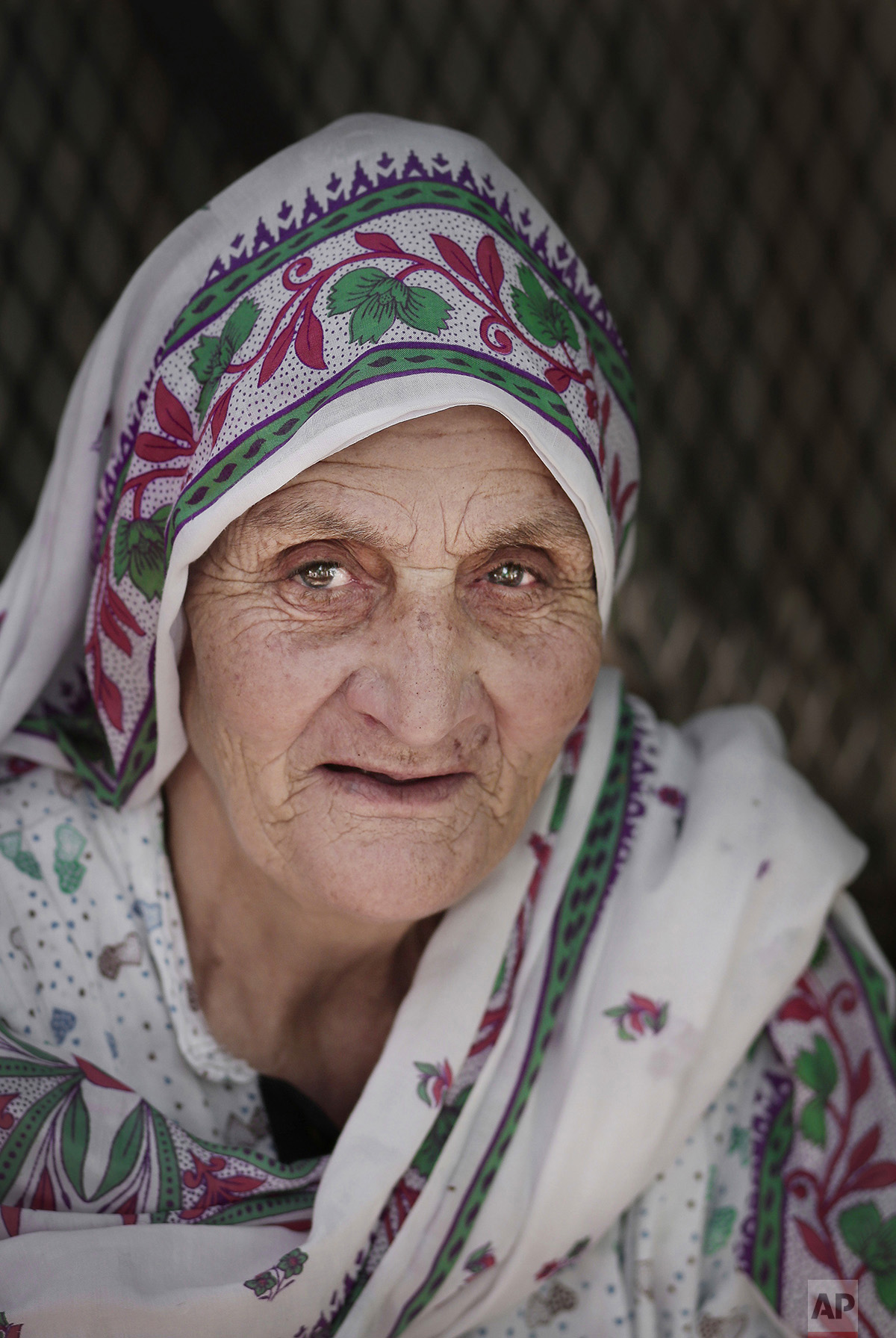  In this Sunday, Sept. 11, 2016 photo, 70-year old Fatma Mohammed from upper Egypt poses for a photograph as she rests in her tent in Arafat, near the holy city of Mecca, Saudi Arabia. Mohammed arrived by bus with a group to make her first Hajj pilgr