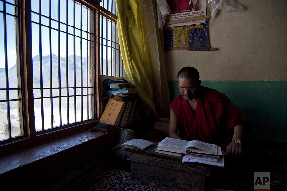  In this Aug. 16, 2016, photo, Buddhist lama Tenzin Rigzin studies religious texts in his room at the Key monastery, Spiti Valley, India. (AP Photo/Thomas Cytrynowicz) 