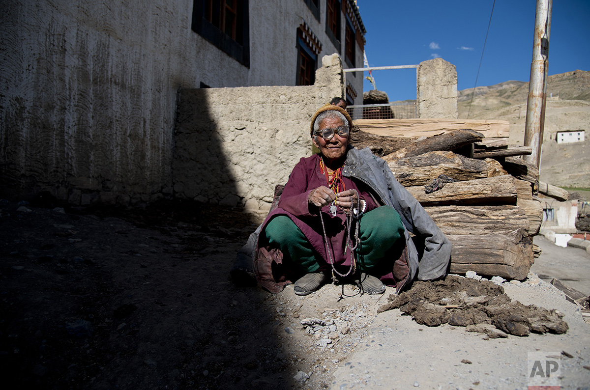  In this Aug. 16, 2016, photo, an elderly woman sits in front of her house in the village of Kibber, in Spiti Valley, India. (AP Photo/Thomas Cytrynowicz) 
