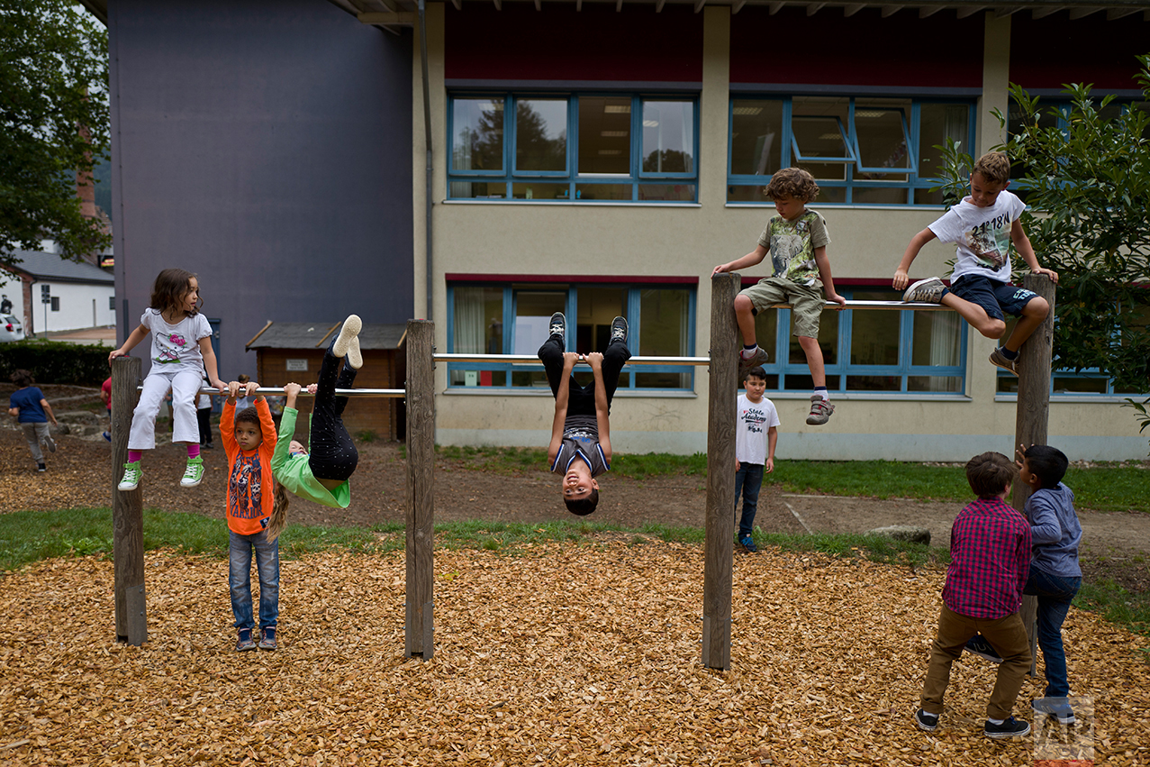  In this Thursday, Sept. 15, 2016 photo, Dildar Qasu, 11, center, a Yazidi migrant from Sinjar, Iraq, plays at his school's play ground during a break at Schulzentrum Oberes Elztal, in Elzach, Germany. (AP Photo/Muhammed Muheisen) 