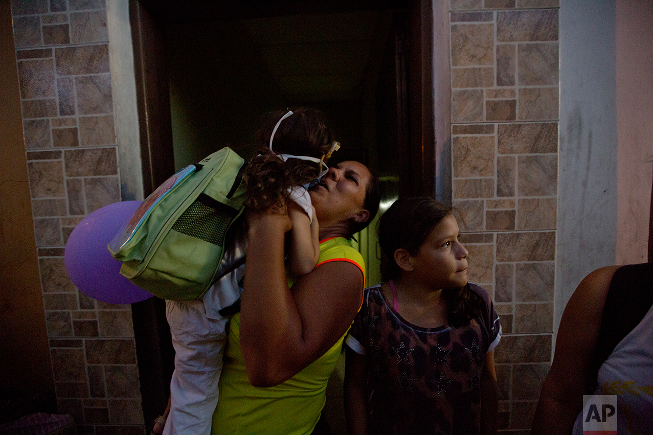 In this Sept. 19, 2016 photo, Ashley Pacheco is welcomed homed after a two-month stay at University Hospital in Caracas, Venezuela. If life in Venezuela has become dangerous for the healthy, it is now deadly for those who fall ill. The government has refused to let in humanitarian aid. So donations of medical supplies sit waiting in warehouses and shipping containers in countries including the U.S., Spain and Panama. (AP Photo/Fernando Llano)