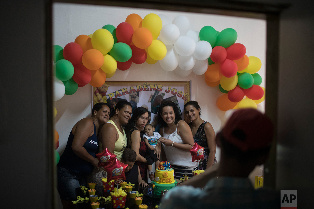 In this Oct. 1, 2016 photo, Rozilene Ferreira and her husband Elias Rodrigo celebrate the one-year birthday of their son Arthur, who was born with microcephaly, in Recife, Pernambuco state, Brazil. (AP Photo/Felipe Dana)