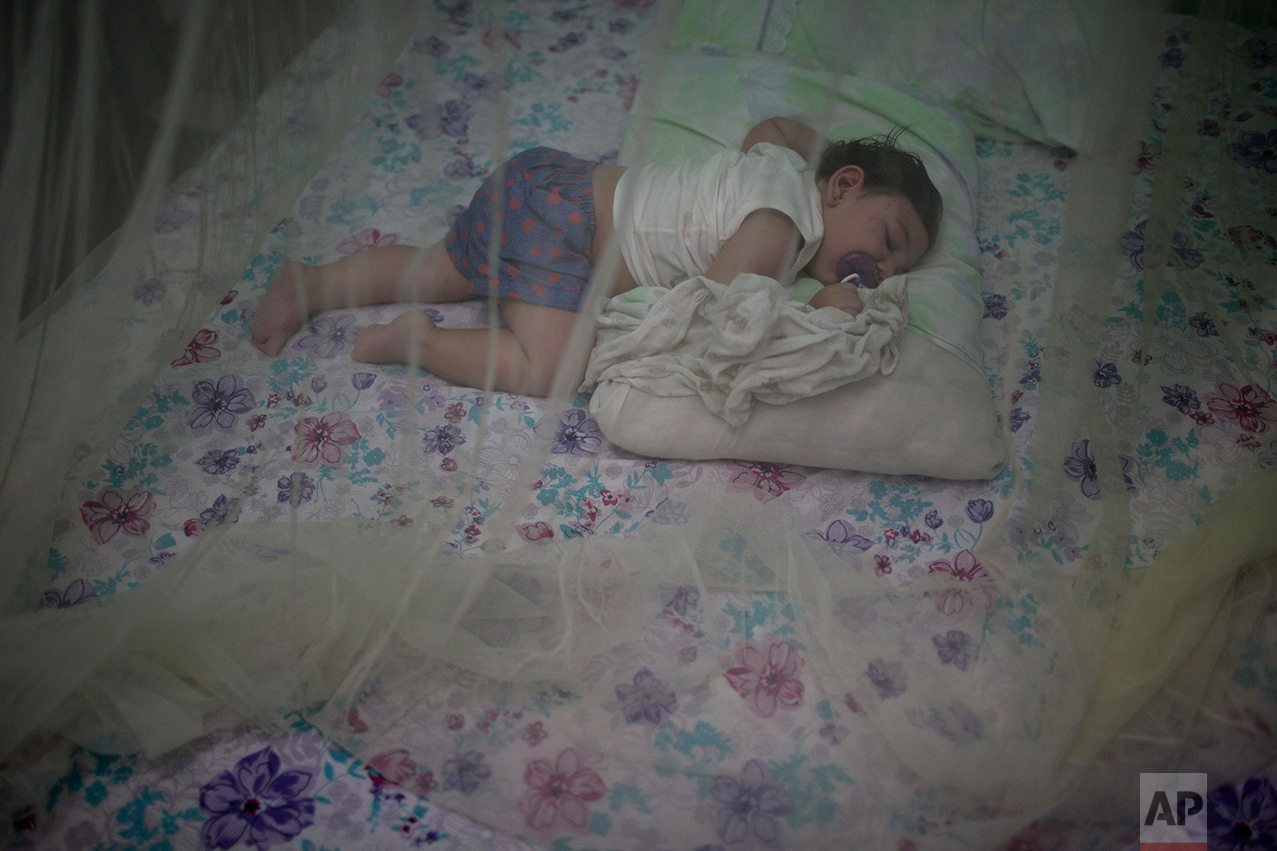 This Sept. 26, 2016 photo shows Luiza, who was born with microcephaly and is almost 1-year-old, sleeping under a mosquito net in her home in Santa Cruz do Capibaribe, Pernambuco state, Brazil. As they reach their first birthdays, babies stricken by Zika in Brazil are developing a host of health problems. The disease is mainly transmitted by mosquito and was not known to cause birth defects until a large outbreak swept through northeastern states in Latin America’s largest nation.(AP Photo/Felipe Dana)