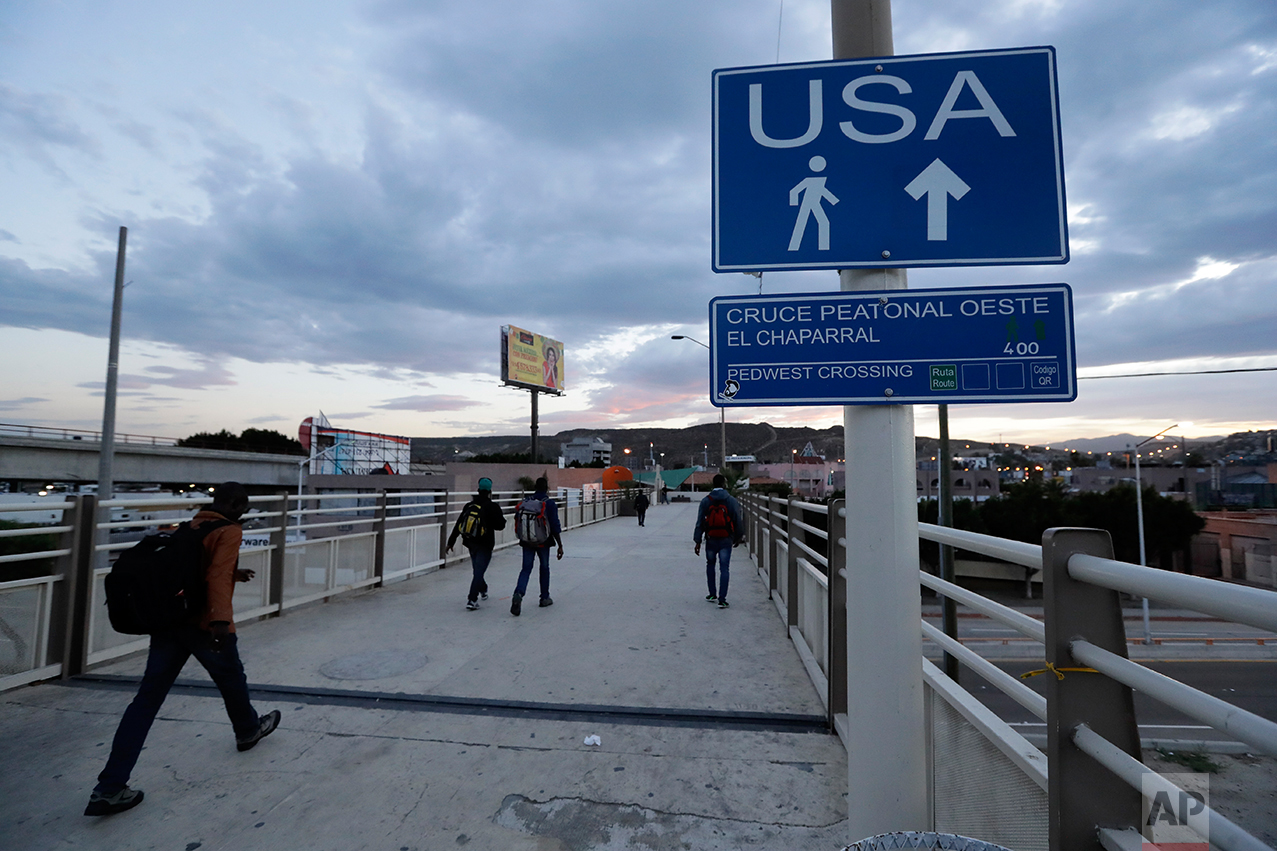 In this Sept. 27, 2016 photo, Haitians make their way towards the border crossing in Tijuana, Mexico. U.S. officials say about 5,000 Haitians showed up at San Ysidro from October 2015 through late last month, and Immigration and Customs Enforcement Director Sarah Saldana said at a recent congressional hearing that officials told her on a trip to Central America that 40,000 more were on their way. (AP Photo/Gregory Bull)