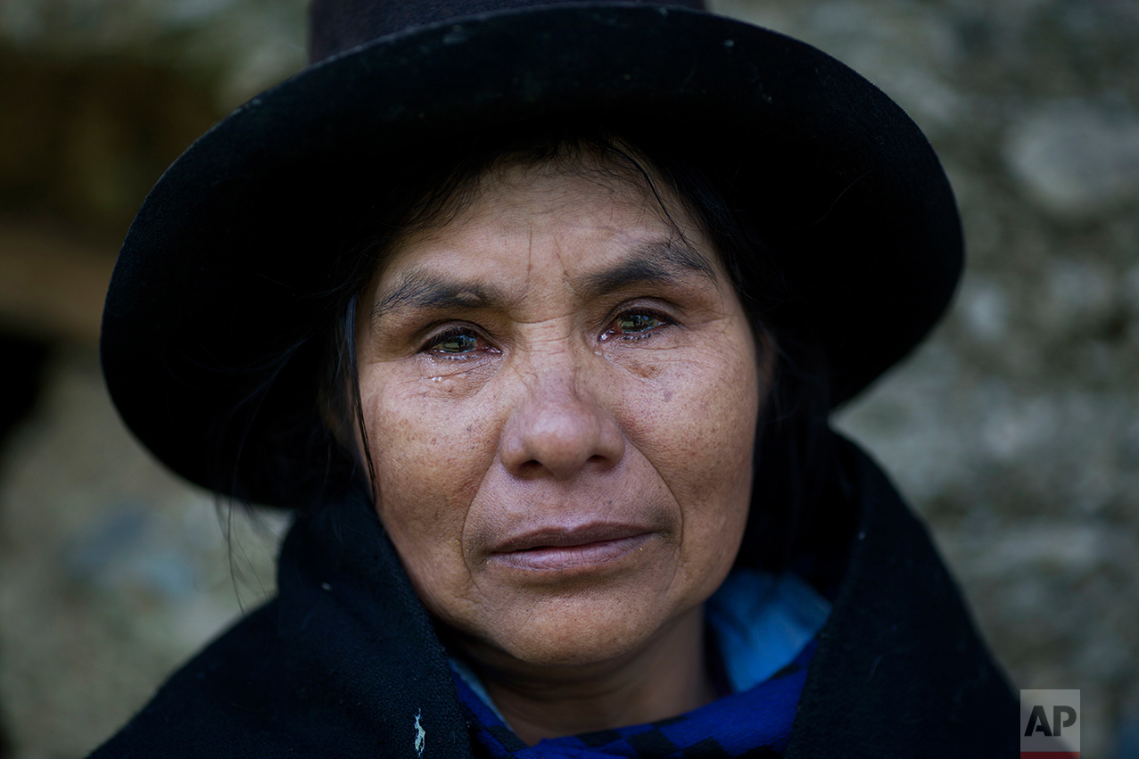  This June 16, 2013 photo shows Eudicia Urbano, 70, in front of her former home near the spot where her husband Marcial Escalante died, weeping as she retells how he was tortured and killed by Shining Path rebels, in Chaca, Peru. The region endured some of the worst atrocities of Peru's 1980-2000 conflict, in which both Maoist-inspired insurgents and security forces committed grave human rights violations. (AP Photo/Rodrigo Abd)
