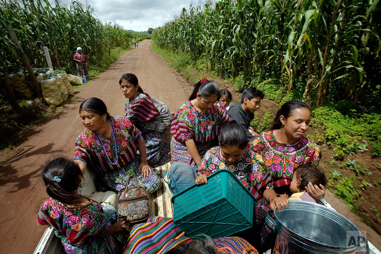 In this Sept. 2, 2008 photo, rural midwife Francisca Raquec, 65, second from left, returns home after shopping at the market in Patzun, Guatemala. In Guatemala, rural midwives deliver six of every ten babies, and the government plans to train 15,000 of them to reduce the number of women who die from child birth. (AP Photo/Rodrigo Abd)