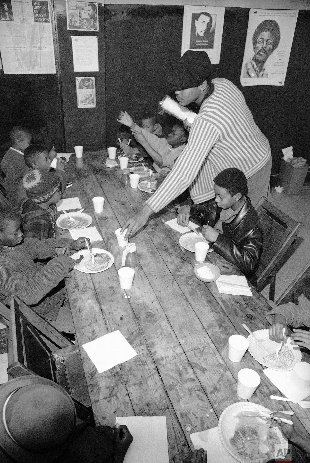 Brad Jones, wearing cap, member of the Philadelphia Black Panthers Organization, helps serve breakfast to youngsters, March 19, 1970 in Philadelphia, Pa., headquarters. (AP Photo/Bill Ingraham)