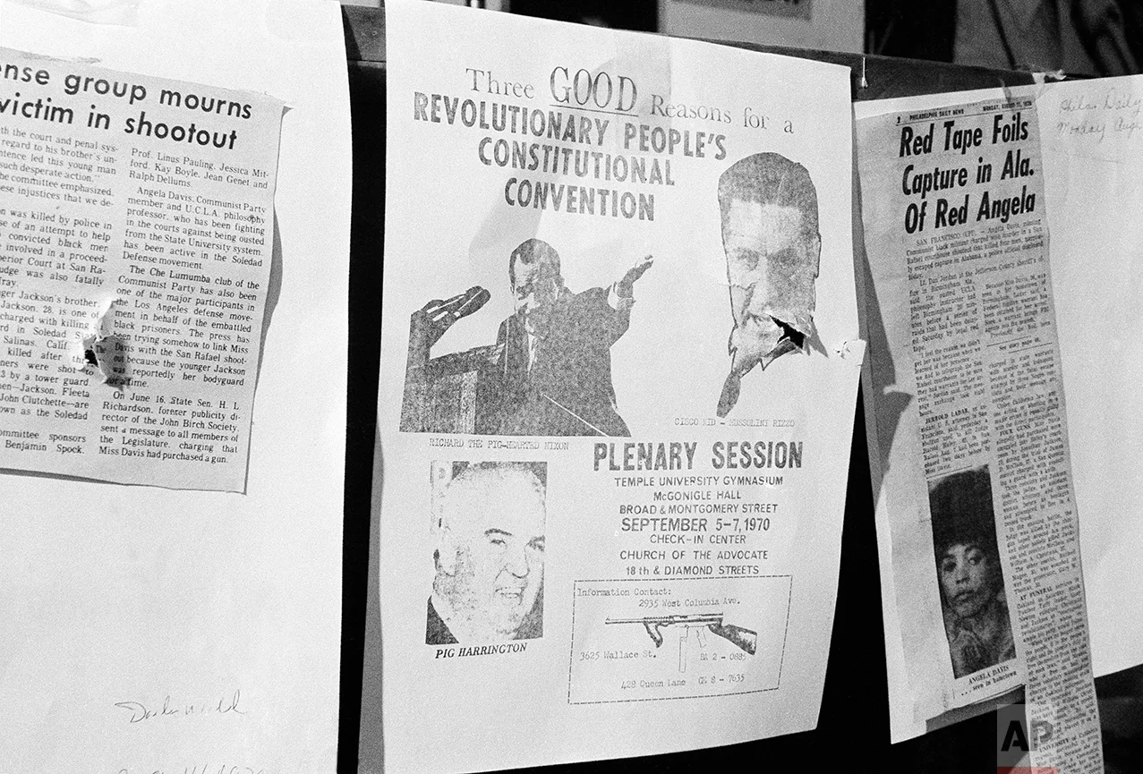 One of the rounds of shots fired by Philadelphia police, Aug. 31, 1970 in a raid on a Black Panther headquarters ripped through a poster which had been affixed to the wall of one of the rooms, announcing the upcoming Black Panther convention in Philadelphia over the weekend. The poster said here was “Three Good Reasons for a revolutionary people’s constructional convention” and showed “Richard, the pig-hearted Nixon” the Cisco kid, Mussolini Rizzo and “Pig (John) Harrington”, head of the Fraternal Order of Police. (AP Photo/Bill Ingraham)