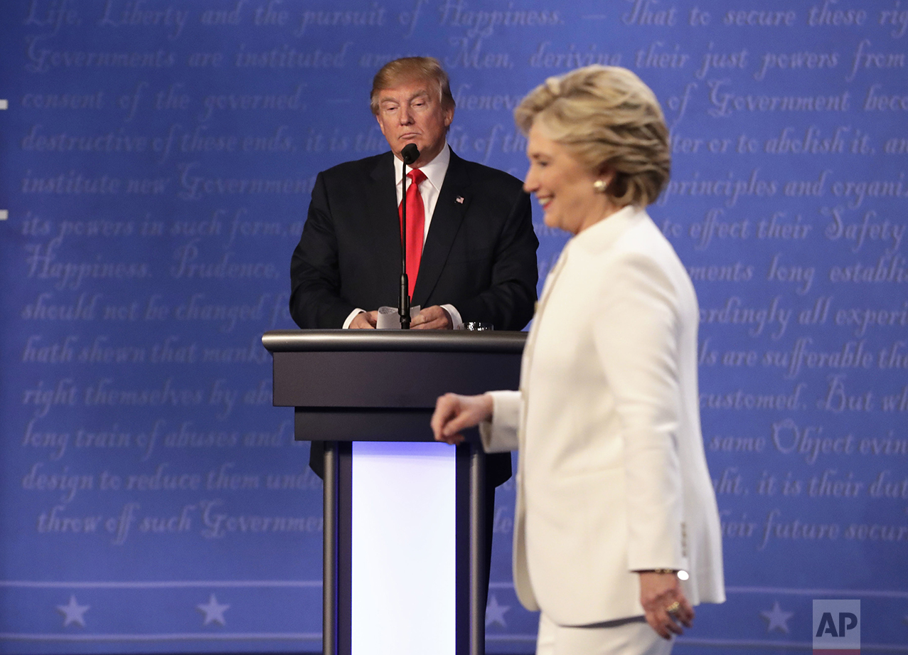 Republican presidential nominee Donald Trump waits behind his podium as Democratic presidential nominee Hillary Clinton makes her way off the stage following the third presidential debate at UNLV in Las Vegas, Wednesday, Oct. 19, 2016. (AP Photo/David Goldman)