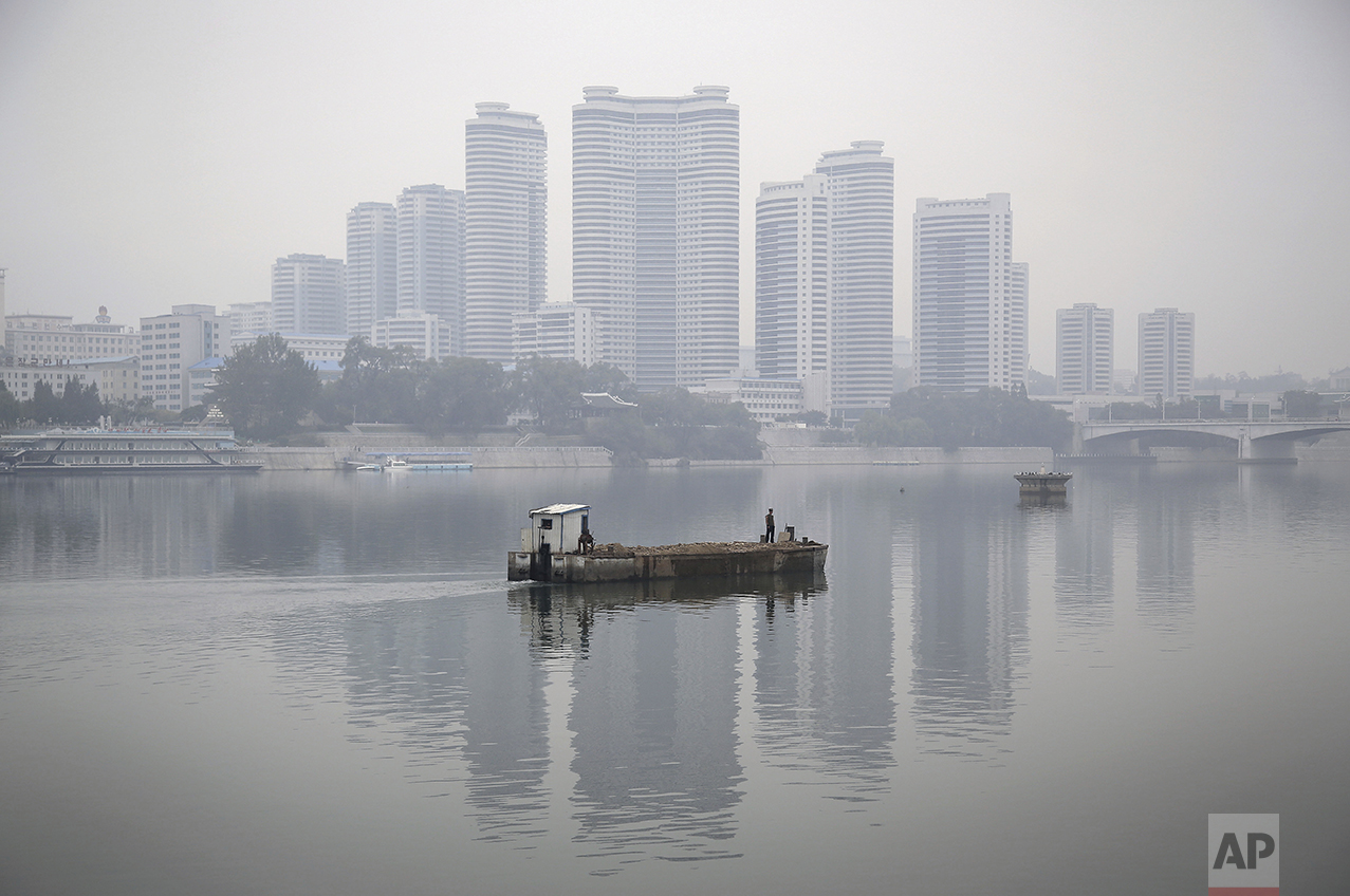 Residential buildings along Changjong Street which form part of the Pyongyang skyline are reflected in the Taedong River on a misty morning on Sunday, Oct. 16, 2016, in Pyongyang, North Korea. (AP Photo/Wong Maye-E)