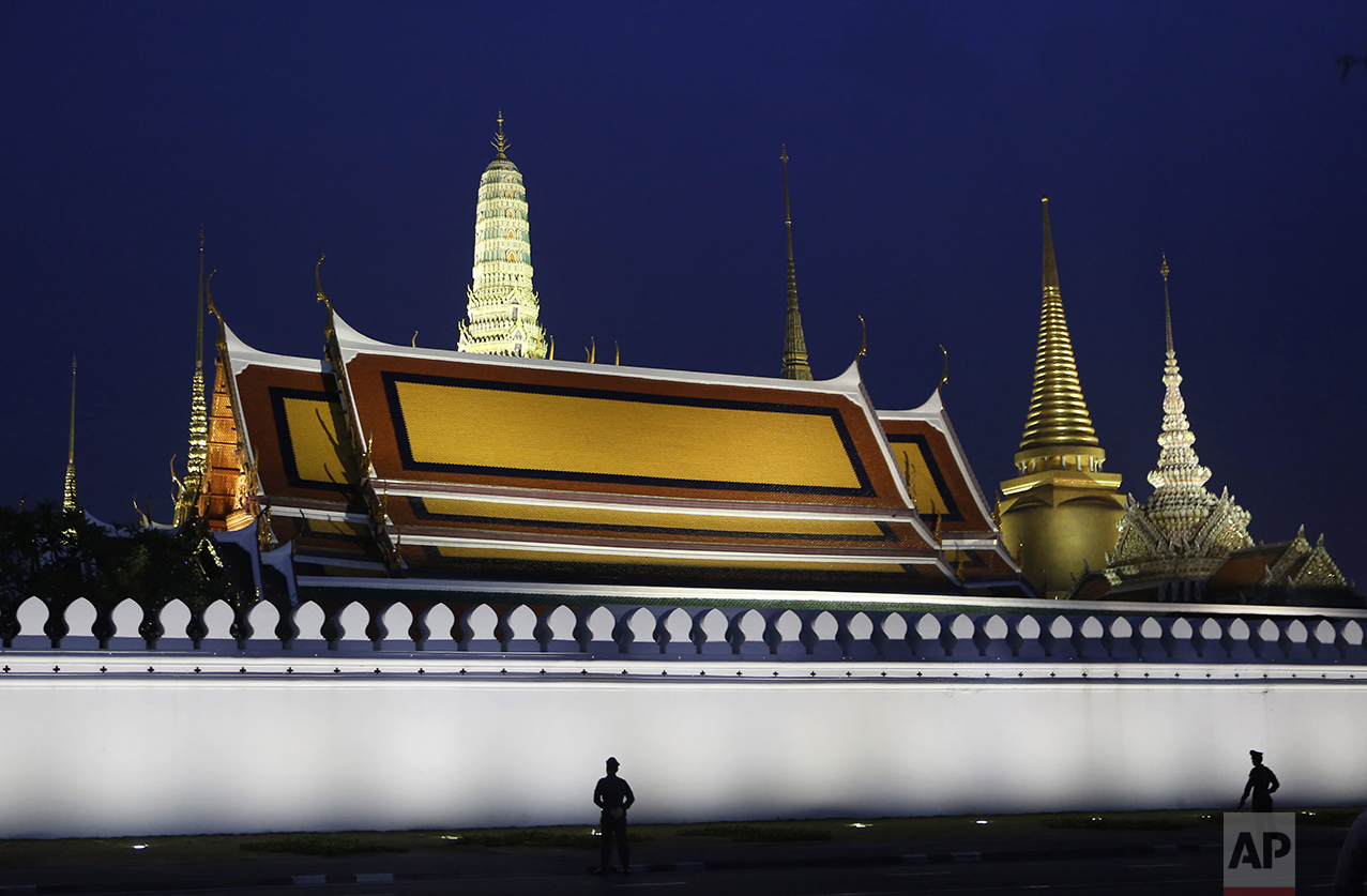 Police guard the Grand Palace where the body of the late Thai King Bhumibol Adulyadej is enshrined in Bangkok, Thailand, Tuesday, Oct. 18, 2016. For Thailand's royalists - millions of them - Bhumibol will probably long remain embedded as a potent, father-like figure who guided them through turbulent decades and espoused ideals of national harmony, labor on behalf of the poor and the virtues of an agrarian society vanishing in the wake of headlong modernization. (AP Photo/Sakchai Lalit)
