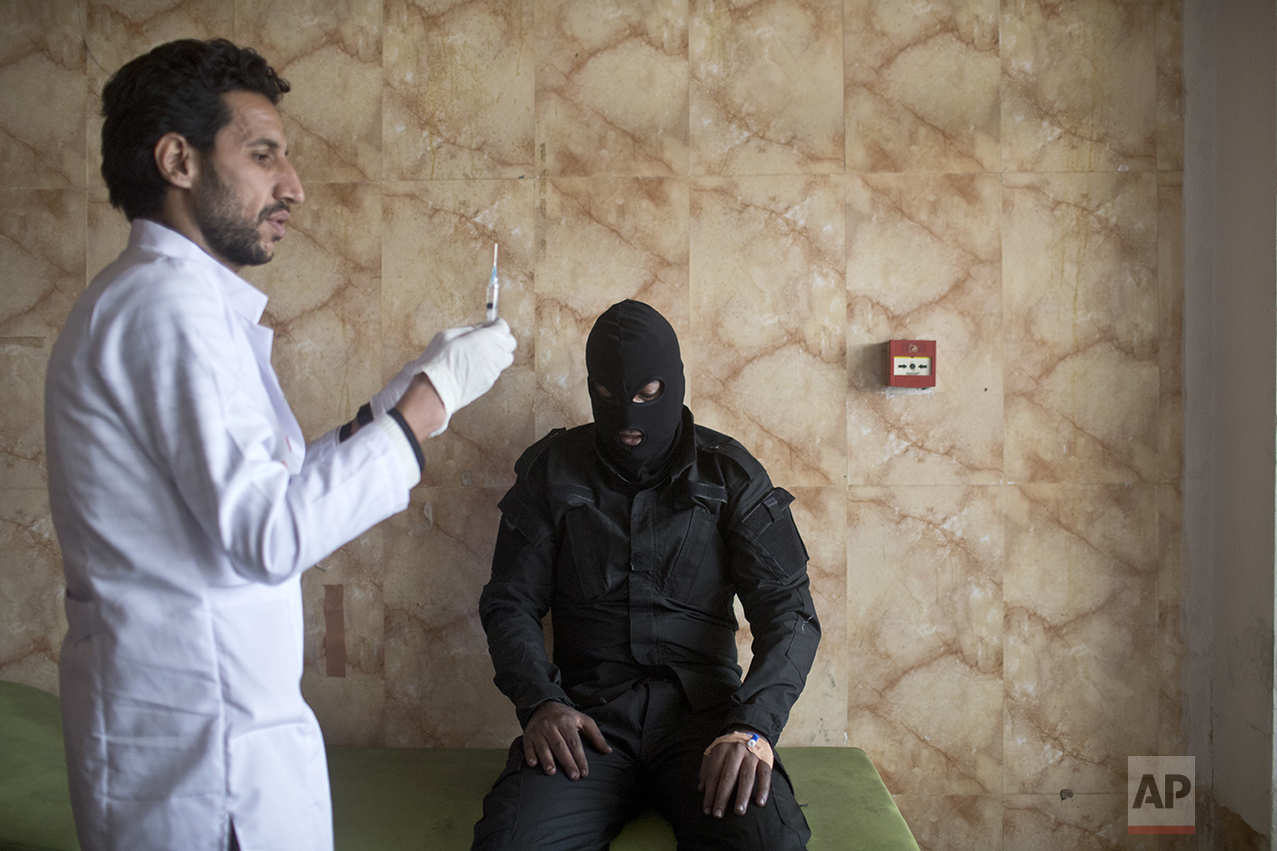 A member of the Iraqi security forces gets medical attention after inhaling sulfur fumes, at a hospital in Qayyarah, about 31 miles (50 km) south of Mosul, Iraq, Sunday, Oct. 23, 2016. Islamic State fighters torched a sulfur plant south of Mosul, sending a cloud of toxic fumes into the air that mingled with oil wells the militants had lit on fire to create a smoke screen. (AP Photo/Marko Drobnjakovic)