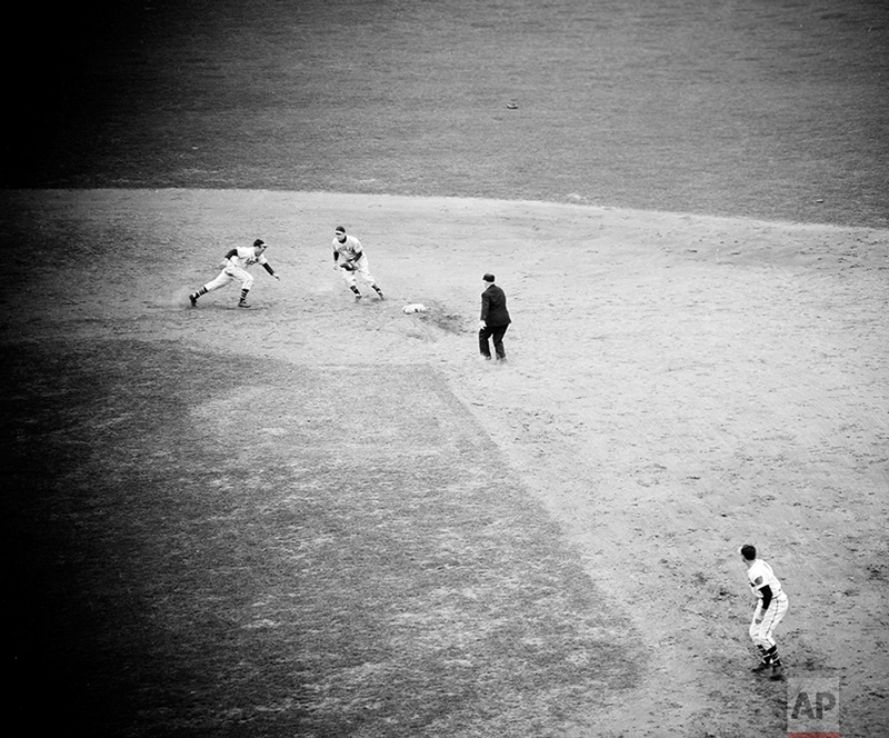 Second base pick off play in the second game of the World Series between the Boston Braves and Cleveland Indians, Oct. 6, 1948, in Boston. Boston catcher Phil Masi heads for the bag as Cleveland manager Lou Boudreau moves in to take the throw with umpire Bill Stewart watching at right. (AP Photo/John Lindsay)