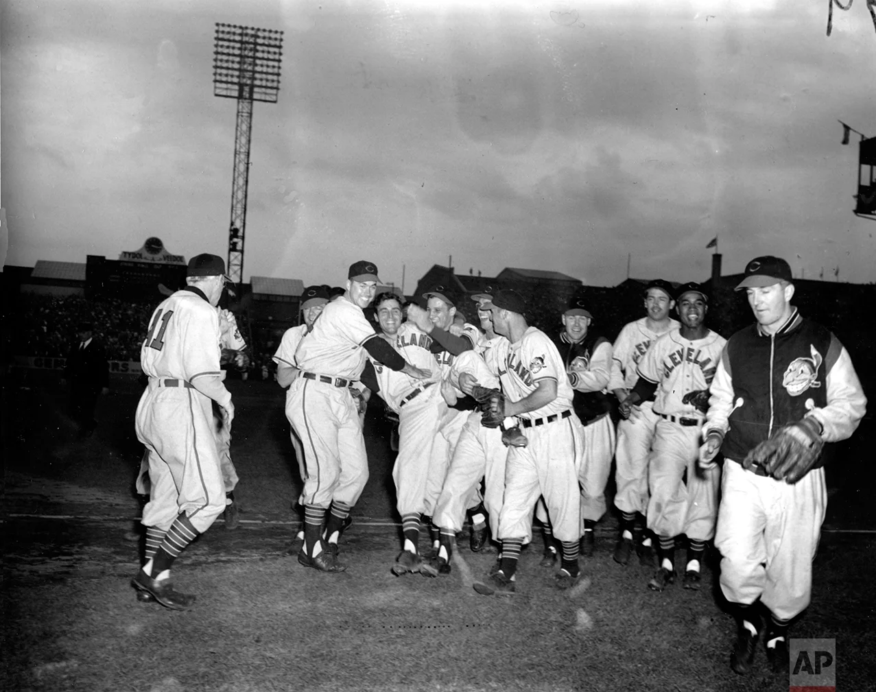 In this Oct. 7, 1948, photo, Cleveland Indians pitcher Bob Lemon, center, is cheered by his teammates after the Indians defeated the Boston Braves in the second game of the 1948 World Series in Boston. Congratulating Lemon at left, facing camera, is manager Lou Boudreau, and at right is pitcher Bob Feller. (AP Photo)