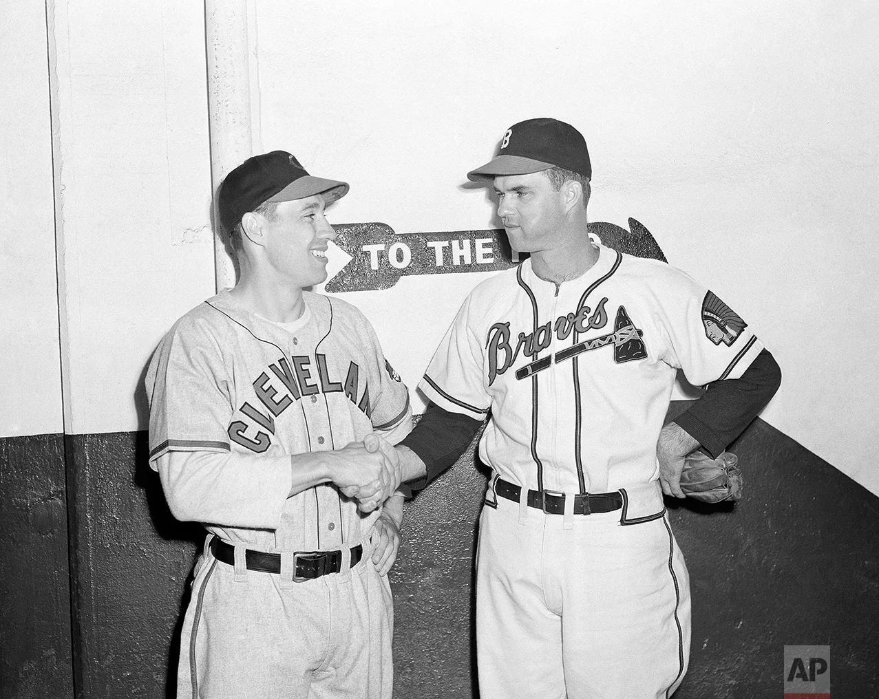 Johnny Sain, right, of the Boston Braves, shakes hands with Cleveland’s Bob Feller, before the two hurling aces took mound, Oct. 6, 1948 at Braves Field, Boston, for the opening game of the 1948 World Series. (AP Photo)