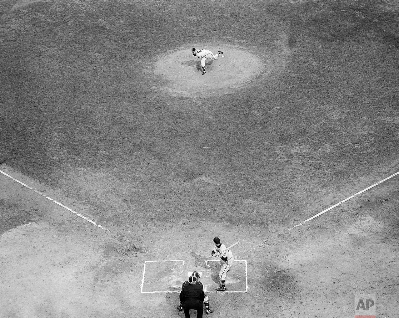 Lefthander Warren Spahn throws the first ball in the second game of the 1948 world series at Braves Field Oct. 7, 1948. Leadoff batter for Cleveland is left fielder Dale Mitchell. Braves catcher is Bill Salkeld and calling play is umpire Bill Summers. Mitchell fouled off the first pitch. (AP Photo)