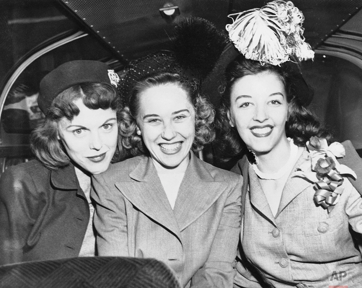 This trio of wives of Cleveland Indian pitchers show their reaction to the Indians 4-1 victory over the Braves in the second series game on Oct. 7, 1948, in Boston as they prepare to depart for Cleveland. From Left to right are Mrs. Robert Feller, whose husband pitched the series opener, Mrs. Robert Lemon, wife of Bob Lemon who hurled and Mrs. Gene Bearden whose husband is expected to take mound in third game tomorrow in Cleveland. (AP Photo)