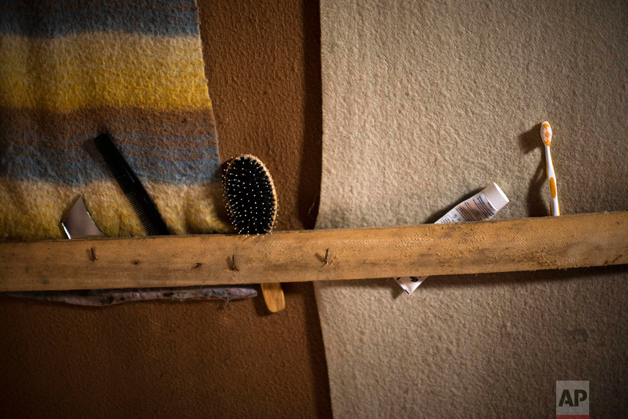 In this Tuesday, Oct. 25, 2016 photo, personal items left behind by their migrant owner remain laid out neatly in an abandoned tent at the makeshift migrant camp known as "the jungle" near Calais, northern France. (AP Photo/Emilio Morenatti)
