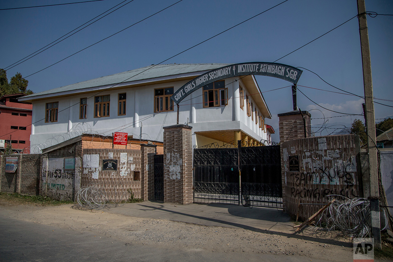 In this Friday, Oct. 21, 2016 photo, barbwire surrounds the Government Girls Higher Secondary Institute after it was converted into a paramilitary bunker in Srinagar, Indian controlled Kashmir. Kashmir has been under a tight security lockdown, along with a separatist-sponsored strike, as Indian forces struggle to quell the uprising and arrest thousands of civilian protesters. The region, also claimed by Pakistan, is divided between the two nuclear-armed neighbors by a heavily militarized Line of Control. (AP Photo/Dar Yasin)