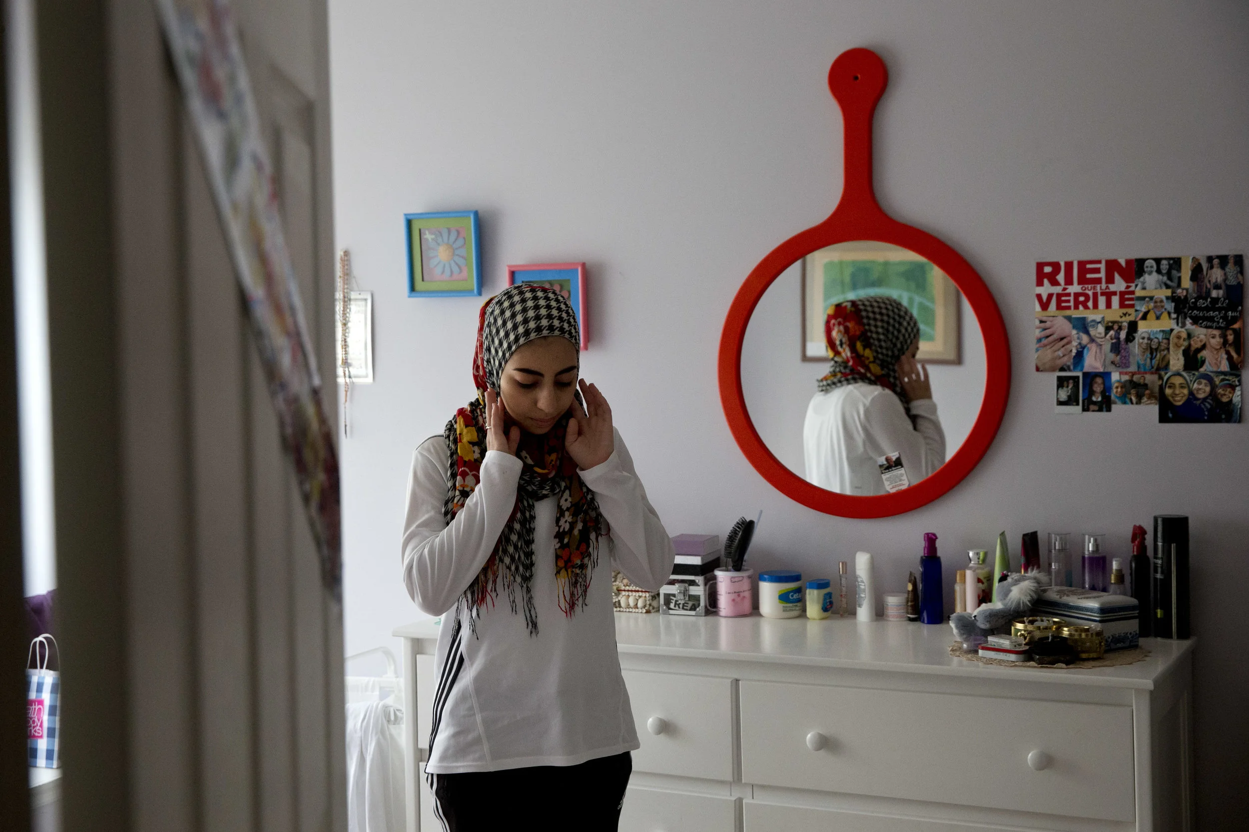 Hannah Shraim, 17, prays in her room at home after finishing her day at Northwest High School in Germantown, Md., Tuesday, May 10, 2016. (AP Photo/Jacquelyn Martin)