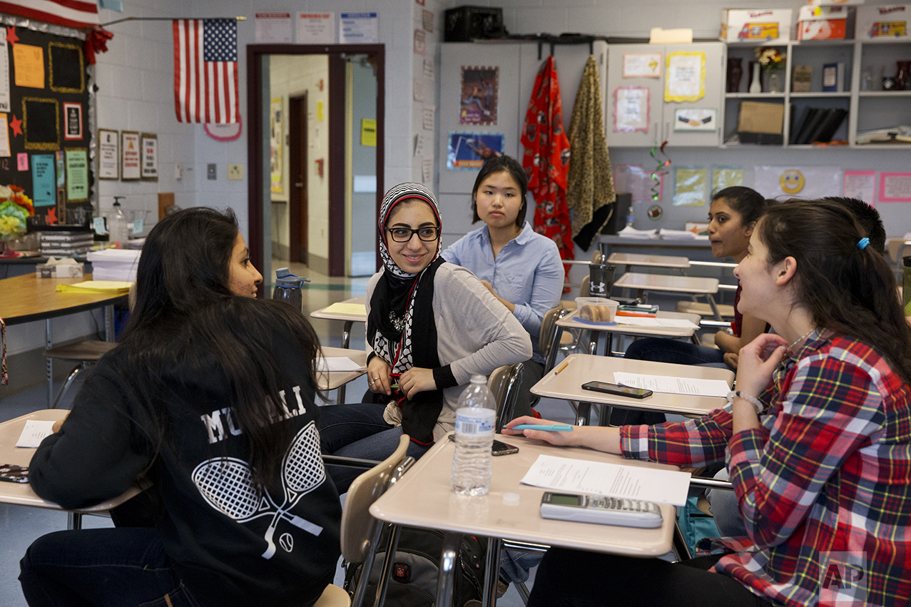 Hannah Shraim, 17, center, turns to chat with other students before an after-hours study session for their math final at Northwest High School in Germantown, Md., Tuesday, May 10, 2016. (AP Photo/Jacquelyn Martin)