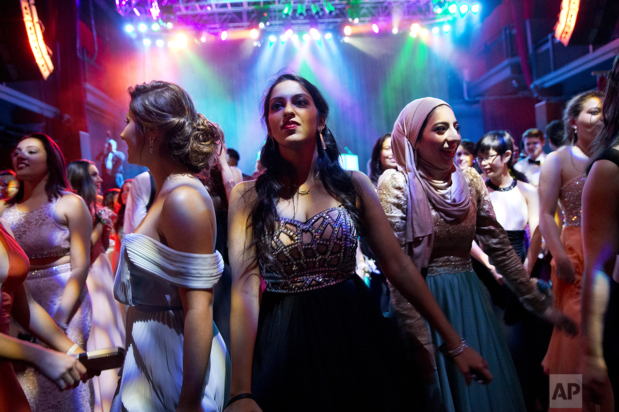 Hannah Shraim, right, dances next to Jahnavi Muralidarin during Northwest High School's senior prom held at the Fillmore Theater in Silver Spring, Md., on Friday, May 13, 2016. (AP Photo/Jacquelyn Martin)