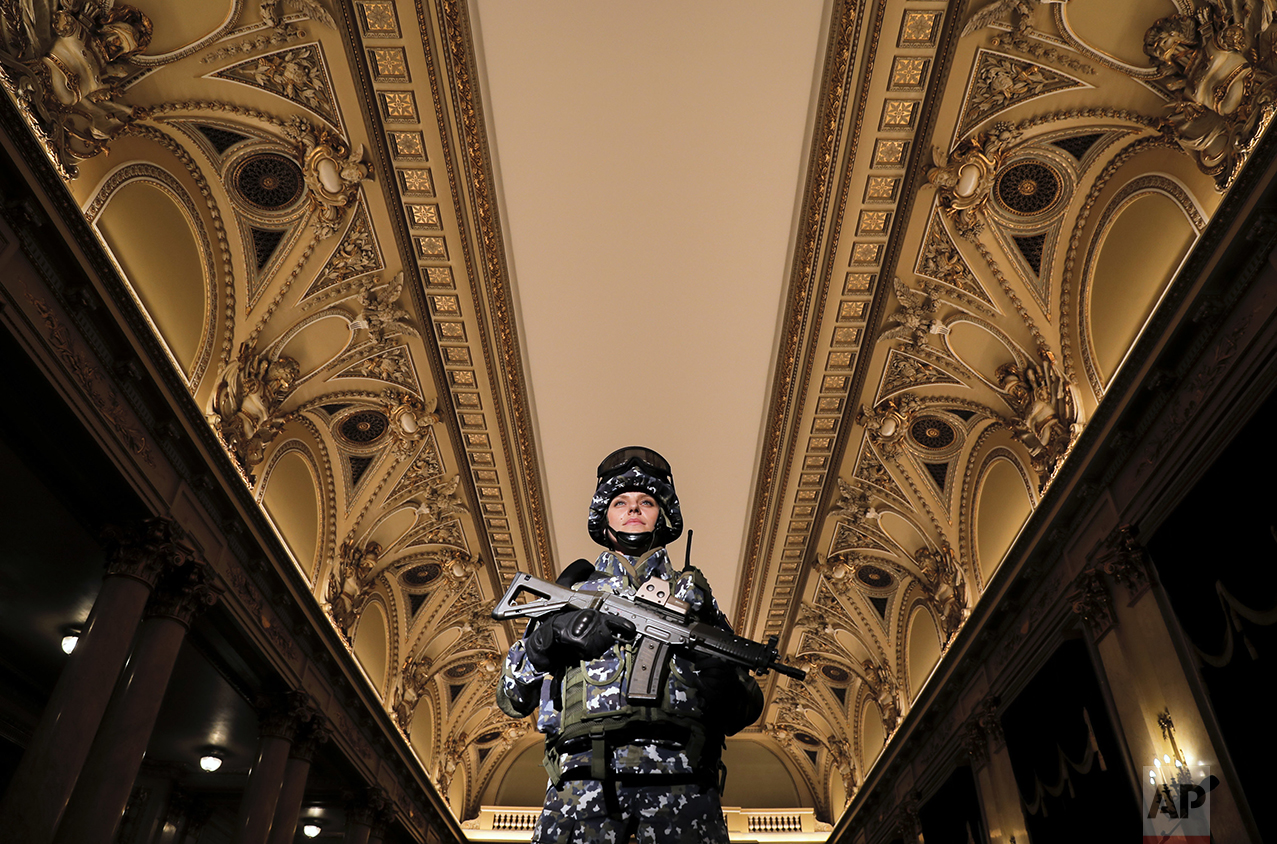 A member of the Romanian armed forces models a future Romanian military combat uniform at the Central Army House in Bucharest, Romania, Tuesday, Oct. 25, 2016, as the country celebrates Army Day marking its liberation from Nazi occupation in 1944. (AP Photo/Vadim Ghirda)