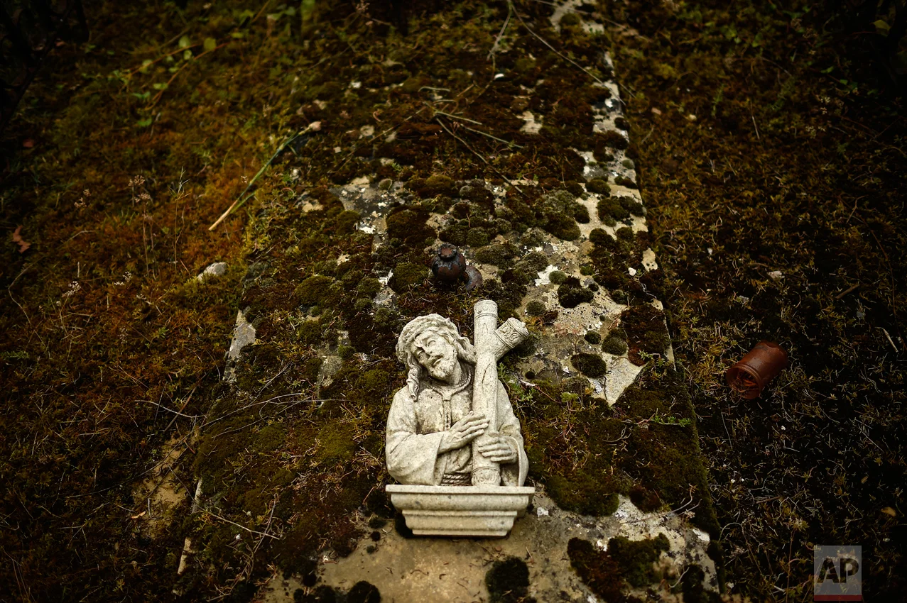 A cross on top of a grave at the state cemetery during All Saints Day, a Catholic holiday to reflect on the saints and deceased relatives, in Pamplona, northern Spain, Tuesday, Nov. 1, 2016. (AP Photo/Alvaro Barrientos)
